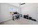 Bright bedroom with a large window, a desk and an office chair, featuring carpeted floors at 3505 Aqua Point Pl, Cumming, GA 30041