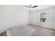 This bedroom has a window for natural light, a ceiling fan and neutral carpet at 3505 Aqua Point Pl, Cumming, GA 30041