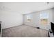 The bonus room features a carpeted floor and natural light coming from the two windows at 3505 Aqua Point Pl, Cumming, GA 30041