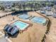 Aerial view showcasing community pool, tennis courts, and playground, creating a vibrant recreation area at 3505 Aqua Point Pl, Cumming, GA 30041