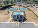 Aerial view of community pool, tennis courts, playground, and parking at 3505 Aqua Point Pl, Cumming, GA 30041