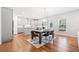 Open-concept dining room and kitchen featuring hardwood floors and stainless steel appliances at 3505 Aqua Point Pl, Cumming, GA 30041