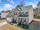 Beautiful two-story brick home with a two-car garage, complemented by landscaped shrubbery at 3505 Aqua Point Pl, Cumming, GA 30041