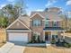 Beautiful two-story brick home with a covered front porch, well-maintained lawn, and attached two-car garage at 3505 Aqua Point Pl, Cumming, GA 30041