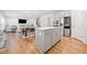 Kitchen with an island and appliances, showcasing the open floor plan to the dining and living area at 3505 Aqua Point Pl, Cumming, GA 30041