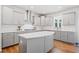 Modern kitchen with stainless steel appliances, gray cabinets, and a central island at 3505 Aqua Point Pl, Cumming, GA 30041