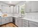 Modern kitchen with stainless steel appliances, gray cabinets, and quartz countertops at 3505 Aqua Point Pl, Cumming, GA 30041