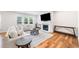 Bright living room featuring a fireplace, large TV, wood floors and comfortable seating at 3505 Aqua Point Pl, Cumming, GA 30041