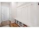 Mudroom features a coat rack with baskets and hooks for storage, adjacent to the hallway and living spaces at 3505 Aqua Point Pl, Cumming, GA 30041