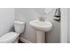 Simple powder room featuring a pedestal sink and toilet with neutral walls at 3505 Aqua Point Pl, Cumming, GA 30041