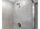 Close up of the gray tiled shower with shower head and modern fixtures at 3505 Aqua Point Pl, Cumming, GA 30041