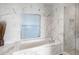 Marble tiled bathroom featuring a soaking tub and separate glass shower at 3630 Peachtree Ne Rd # 2009, Atlanta, GA 30326