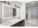 Contemporary bathroom with double sink vanity, illuminated mirror, and marble tile at 3630 Peachtree Ne Rd # 2009, Atlanta, GA 30326