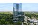 Modern high-rise building featuring glass facade and lush surrounding landscape at 3630 Peachtree Ne Rd # 2009, Atlanta, GA 30326