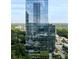 Modern high-rise building featuring glass facade and lush surrounding landscape at 3630 Peachtree Ne Rd # 2009, Atlanta, GA 30326