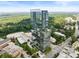 An elevated view of the high-rise building surrounded by lush greenery and a clear sky at 3630 Peachtree Ne Rd # 2009, Atlanta, GA 30326