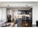 Modern kitchen with stainless steel appliances, dark wood cabinets, granite countertops, and breakfast bar at 3630 Peachtree Ne Rd # 2009, Atlanta, GA 30326