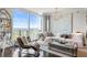 Bright living room featuring floor-to-ceiling windows, a plush white sofa, and unique decorative accents at 3630 Peachtree Ne Rd # 2009, Atlanta, GA 30326
