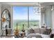 Bright living room with stunning views, decorative mirror, white sofa, and unique light fixture at 3630 Peachtree Ne Rd # 2009, Atlanta, GA 30326
