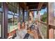 Relaxing outdoor balcony featuring stylish seating, wood floors, and beautiful views at 5910 Bond St # 401, Cumming, GA 30040