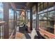 Relaxing outdoor balcony featuring stylish seating, wood floors, and beautiful views at 5910 Bond St # 401, Cumming, GA 30040