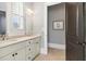 Elegant bathroom featuring double sinks, ample lighting, and a stylish design with neutral colors and fixtures at 5910 Bond St # 401, Cumming, GA 30040