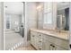 Bright bathroom with double sinks, shutters, and a view into a connected bedroom area at 5910 Bond St # 401, Cumming, GA 30040