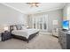 Calm bedroom featuring a comfortable bed, soft carpet, and ample natural light from the window at 5910 Bond St # 401, Cumming, GA 30040