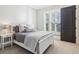 Well-lit bedroom with white walls, large windows, and simple decor at 5910 Bond St # 401, Cumming, GA 30040
