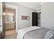 Bedroom with ensuite bath featuring elegant design with a tennis racket displayed and grey, white, and brown tones at 5910 Bond St # 401, Cumming, GA 30040