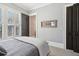 Bedroom with a tennis racket art piece and large windows at 5910 Bond St # 401, Cumming, GA 30040