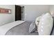 Cozy bedroom with gray bedding and a framed tennis racket wall art at 5910 Bond St # 401, Cumming, GA 30040