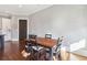 Cozy dining area with a wooden table set for four, set next to the bright white kitchen at 5910 Bond St # 401, Cumming, GA 30040