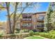 Beautiful multi-story brick building with private balconies and lush landscaping at 5910 Bond St # 401, Cumming, GA 30040