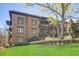 Brick building featuring multiple balconies, decorative accents, and a well-maintained lawn at 5910 Bond St # 401, Cumming, GA 30040