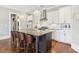 Modern kitchen features white cabinets, stainless steel appliances, and a granite countertop island with seating at 5910 Bond St # 401, Cumming, GA 30040