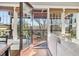 Bright living room featuring hardwood floors, neutral walls, and access to a deck with wooded views at 5910 Bond St # 401, Cumming, GA 30040
