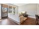 Cozy living room with hardwood floors, large windows, and views of a tranquil outdoor space at 5910 Bond St # 401, Cumming, GA 30040