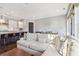 Open-concept living space with a modern kitchen, a large sofa, and an eat-in kitchen island at 5910 Bond St # 401, Cumming, GA 30040