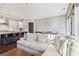 Inviting open-concept living room and kitchen with a large sectional sofa and bar stool seating at 5910 Bond St # 401, Cumming, GA 30040