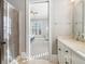 Bathroom with a glass-enclosed shower and double-sink vanity at 5910 Bond St # 401, Cumming, GA 30040