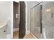 Bathroom with glass enclosed shower and tan tiled walls at 5910 Bond St # 401, Cumming, GA 30040