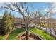 Landscaped yard with mature trees, lush lawns, and views of the neighborhood beyond, under a blue sky at 5910 Bond St # 401, Cumming, GA 30040