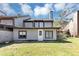 Two-story home featuring a chimney, a white door, and a well-manicured lawn at 109 Willowick Dr # 109, Lithonia, GA 30038