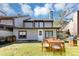 Back yard with a wooden outdoor dining set, grill, and well-manicured lawn at 109 Willowick Dr # 109, Lithonia, GA 30038