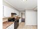 Bright kitchen features white cabinets, laminate countertops, and a black range oven with a tile backsplash at 109 Willowick Dr # 109, Lithonia, GA 30038