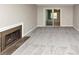 Bright living room with new carpet, neutral paint, and a fireplace with glass sliding doors to the sun room at 109 Willowick Dr # 109, Lithonia, GA 30038