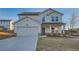Charming two-story home featuring a covered porch, attached garage, and well-manicured lawn at 123 Ledgemont Way, Acworth, GA 30101