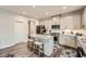 Modern kitchen features stainless steel appliances, a granite island with seating, and gray cabinetry at 123 Ledgemont Way, Acworth, GA 30101