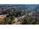 An aerial view highlights the property surrounded by mature trees, providing a secluded and peaceful setting at 2107 Penrose Dr, Atlanta, GA 30344